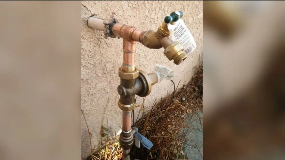 Water heater valve and copper piping connection inspected during repair in Monrovia